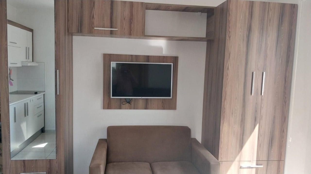 Lounge with a sofa, television and fitted wardrobes